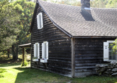 cabin in a clearing in the woods