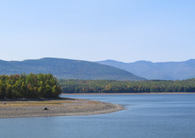 Wide view of reservoir under clear blue skies.